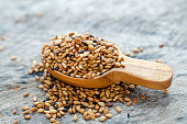 Dry organic roasted white and black sesame seed pile in wooden spoon on grunge background, for food ingredient concept