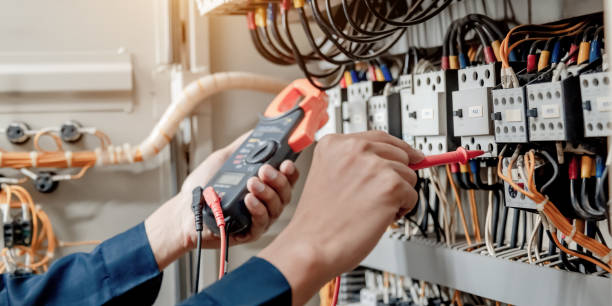 istock Electrician engineer uses a multimeter to test the electrical installation and power line 1324499011