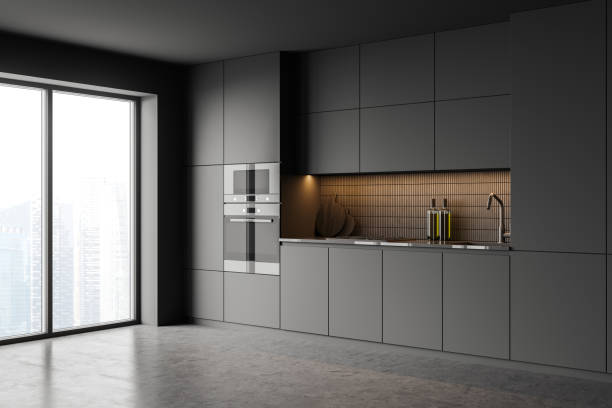 istock Gray kitchen interior with cupboards and built in appliances 1324500135