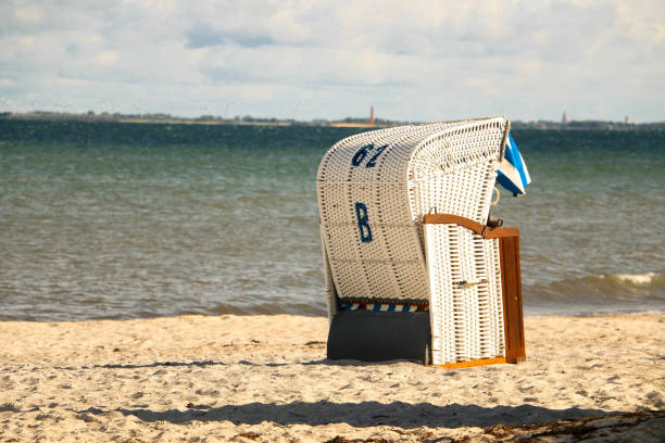 istock blue and white beach chair is standing at the beach 1324501896