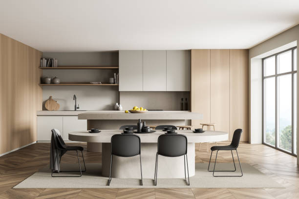 istock Light and wooden kitchen interior with table and chairs near window 1324502835