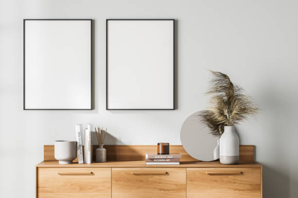 istock Light art room interior with drawer, books and decoration, mock up posters 1324502869