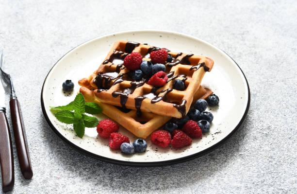 istock Vanilla Belgian waffles with berries and a cup of coffee for breakfast. 1324504054