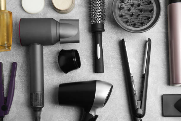 istock Flat lay composition with hairdressing equipment on grey stone background 1324505326