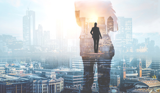 Businessman silhouette against the City view, modern skyscrapers of financial area of London. Business concept