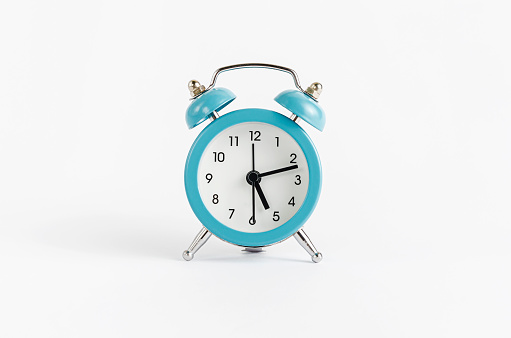Blue alarm clock on white background. Time and deadline concept