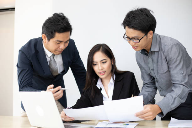 istock Asian businessmen and group using notebook for business partners discussing documents and ideas at meeting and business women smiling happy for working 1324514323
