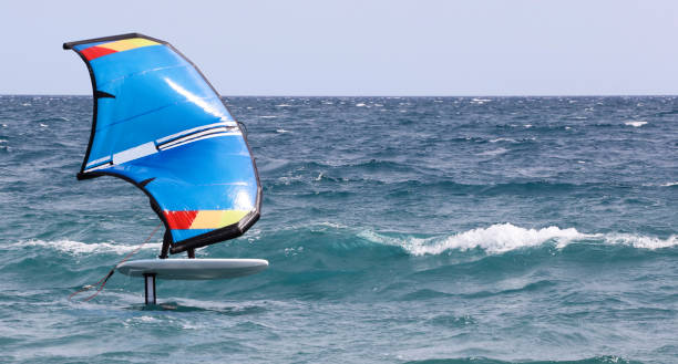 istock rider on a wind foil board, surf the waves 1324514478