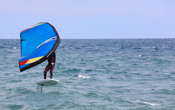 istock rider on a wind foil board, surf the waves 1324514487