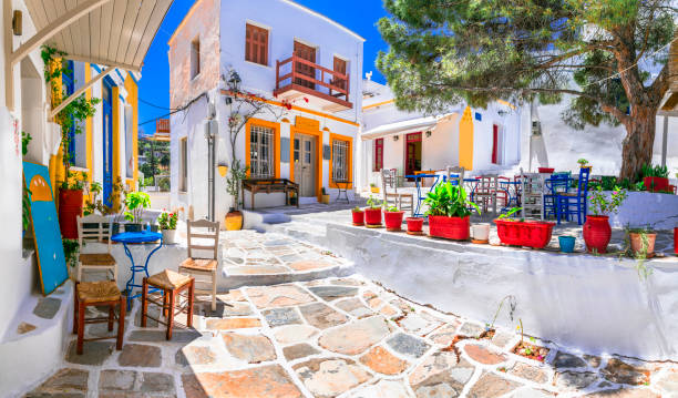 Beautiful Lefkes traditional greek village in Paros island. Charming coffe bars and taverns in colorful narrow streets. Cyclades , Greece Beautiful Lefkes traditional greek village in Paros island. Charming coffe bars and taverns in colorful narrow streets. Cyclades , Greece paros stock pictures, royalty-free photos & images