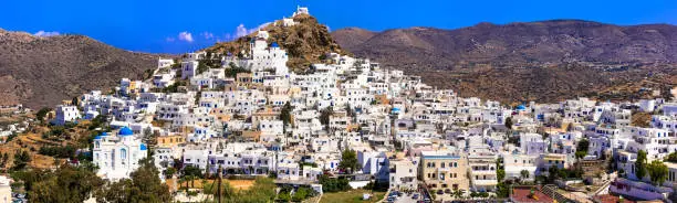 Photo of Picturesque authentic Ios island. View of scenic old town Chora with whitewashed houses and blue churches