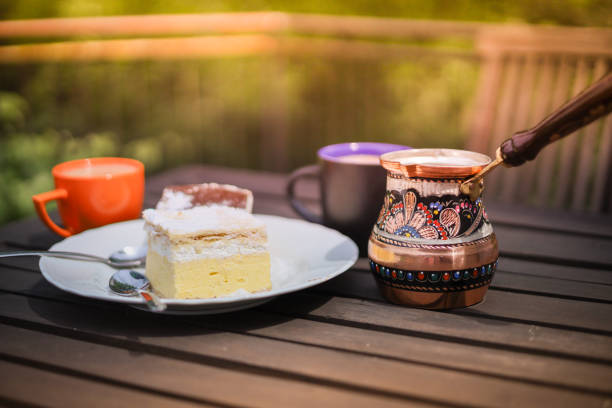 istock Rustic breakfast. Wooden coffee table with coffee cups, cezve, lake Bled cream cake 1324514783