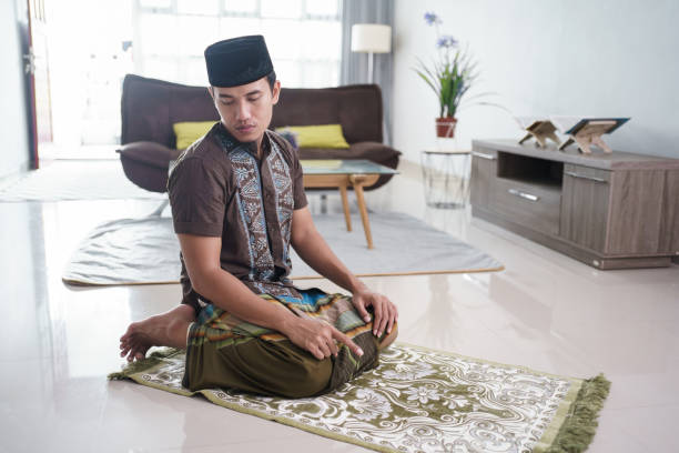 istock Young Muslim man praying at home 1324515773
