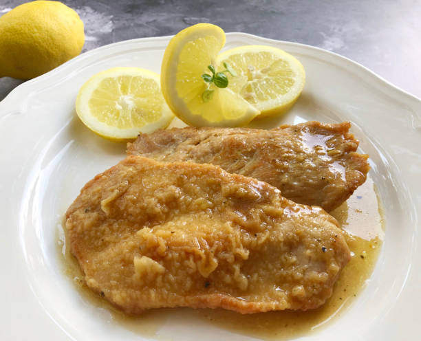 Fried turkey Escalope, also known als natural schnitzel, or scaloppini with gravy and fresh lemon. Fried turkey Escalope, also known als natural schnitzel, or scaloppini with fresh lemon. scaloppini stock pictures, royalty-free photos & images