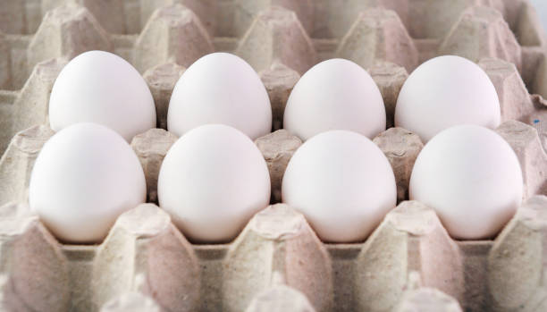 istock Farm egg in paper container. Isolated on white background. 1324519430