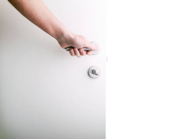 istock The hand opens the white door to the void. 1324519458