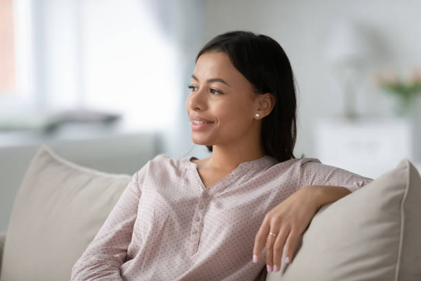 istock Happy relaxed African American homeowner resting on comfortable couch 1324522223