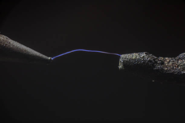 istock Electric cable close-up with glowing electricity lightning. Macro shot 1324525189