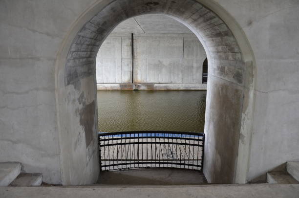istock cement arch or wall with canal or river water 1324525267