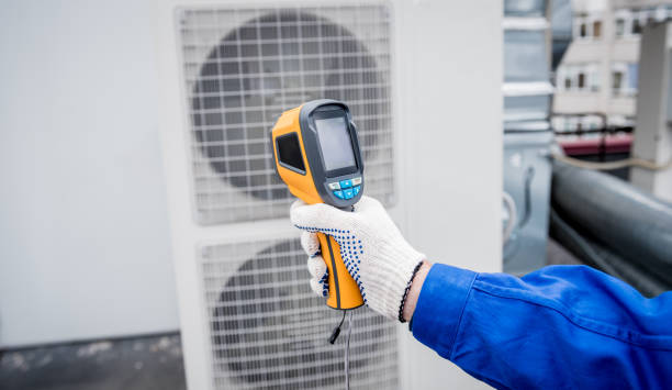 istock Technician uses a thermal imaging infrared thermometer to check the condensing unit heat exchanger. 1324529086