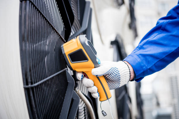 istock Technician uses a thermal imaging infrared thermometer to check the condensing unit heat exchanger. 1324529771