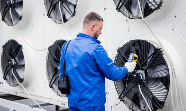 istock Technician uses a thermal imaging infrared thermometer to check the condensing unit heat exchanger. 1324530456