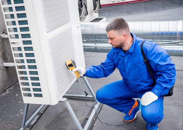 Technician uses a thermal imaging infrared thermometer to check the condensing unit heat exchanger.