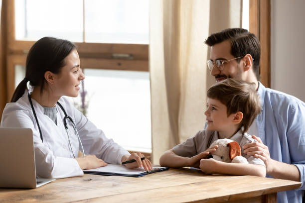 istock Female doctor consult small child visiting with dad 1324531961