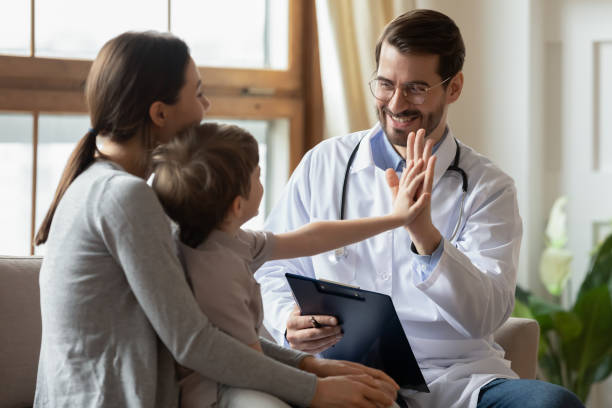 Happy doctor have fun greet with little boy patient