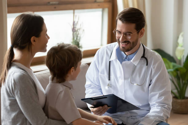 istock Smiling doctor examine small boy patient at consultation 1324531981