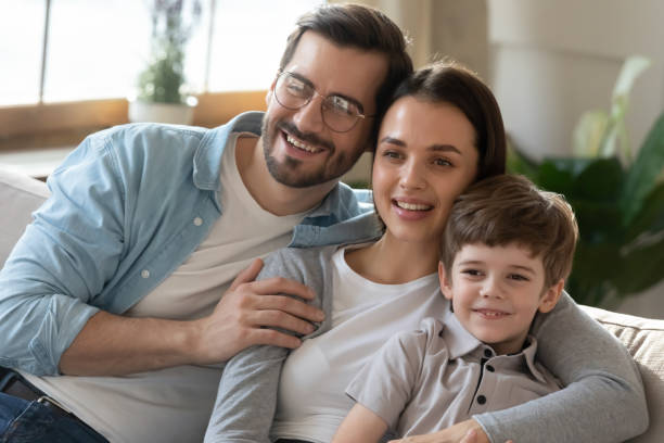 istock Smiling family with small son relax at home together 1324532013
