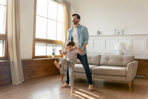 istock Overjoyed father and son dancing at home 1324532015