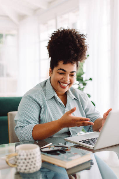 istock Woman working remotely video calling with laptop 1324533087