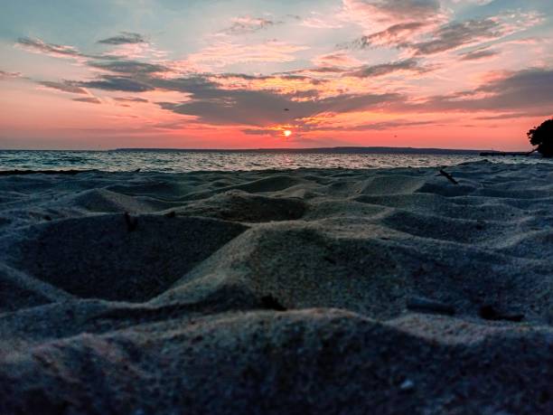 istock Sand on the beach with sunset 1324534381