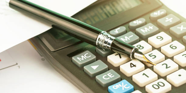 istock designed black pen lies on outdated calculator macro 1324534582