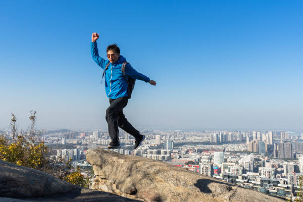 istock Asian man jumping over the gully on the mountain 1324534660