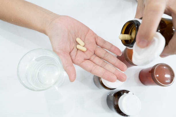 istock medicine on hand with white background. 1324535642