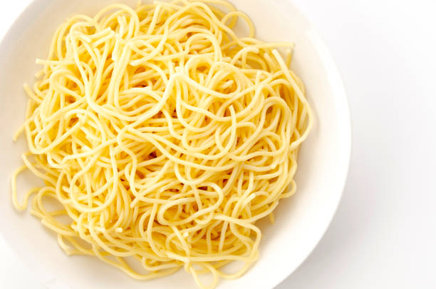 istock Spaghetti Noodles in Plate on White Background 1324535718