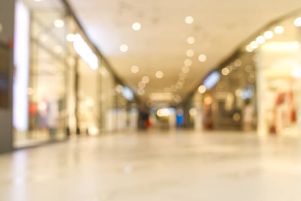 istock shopping mall blurred background. Light blur store interior with bokeh 1324535771