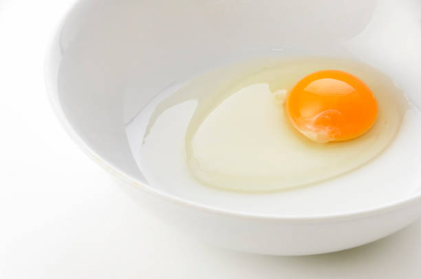istock yellow egg yolks in a white bowl 1324536595