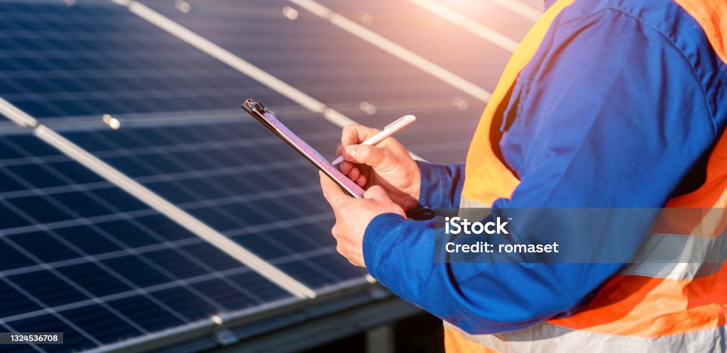 Inspector examination of photovoltaic modules using a thermal imaging camera Inspector examination of photovoltaic modules using a thermal imaging camera. Medical Exam Stock Photo