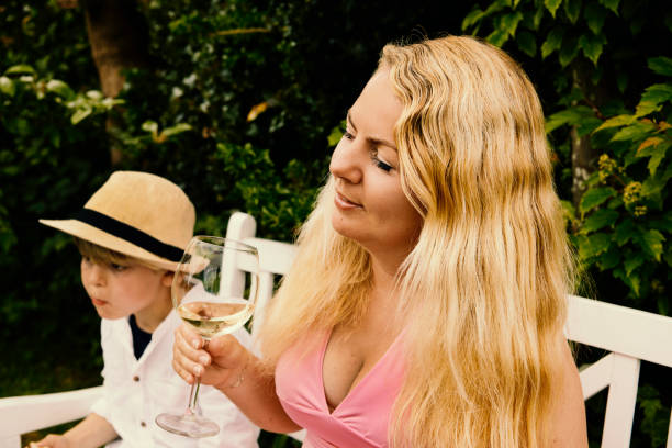 Blond Caucasian mother with long hair and son in outdoors portrait