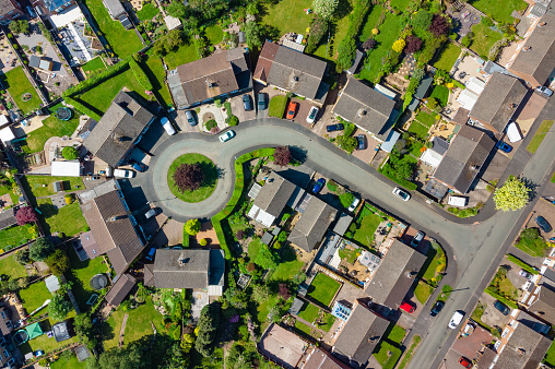 Top down aerial view of typical suburban estate including large houses and gardens in England, UK
