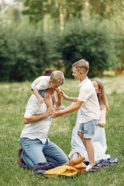istock Cute family playing in a summer field 1324538991