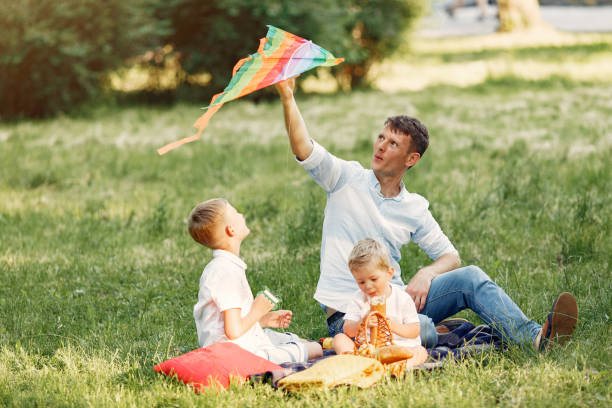 istock Cute family playing in a summe field 1324539014