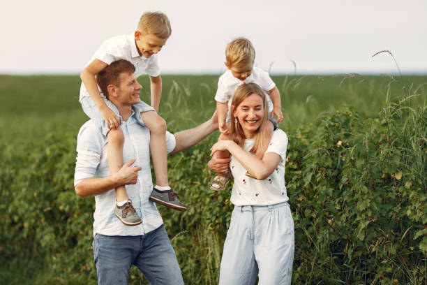 istock Cute family playing in a summer field 1324539073