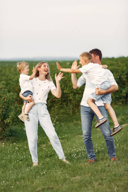 istock Cute family playing in a summer field 1324539105