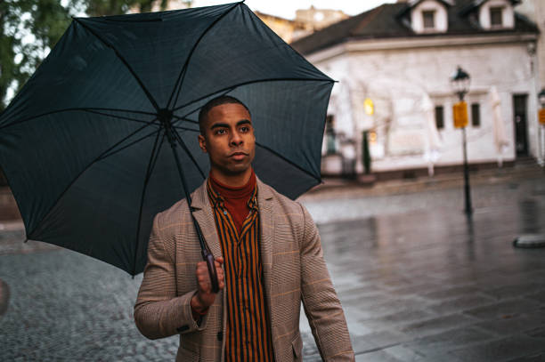istock A businessman carries an umbrella 1324540263