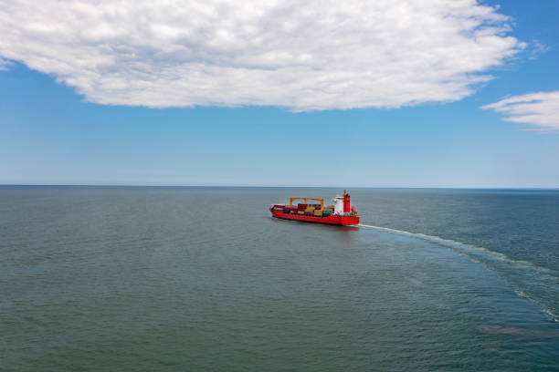 istock Aerial view of a container cargo ship traveling over open sea. 1324541549