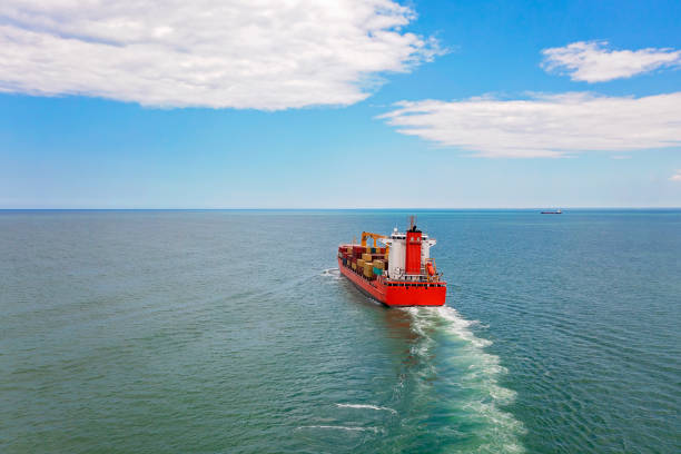 istock Aerial view of a container cargo ship traveling over open sea. 1324542543